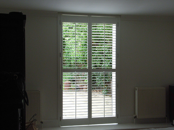 Full height plantation shutter doors in wood with 63mm louvres