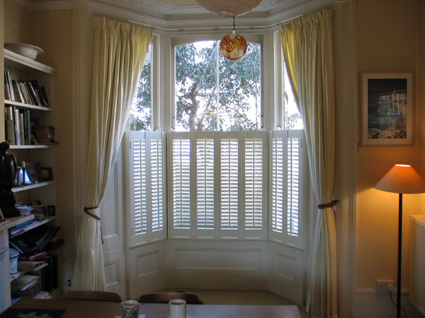 Cafe height plantation shutters in wood with 47mm louvres