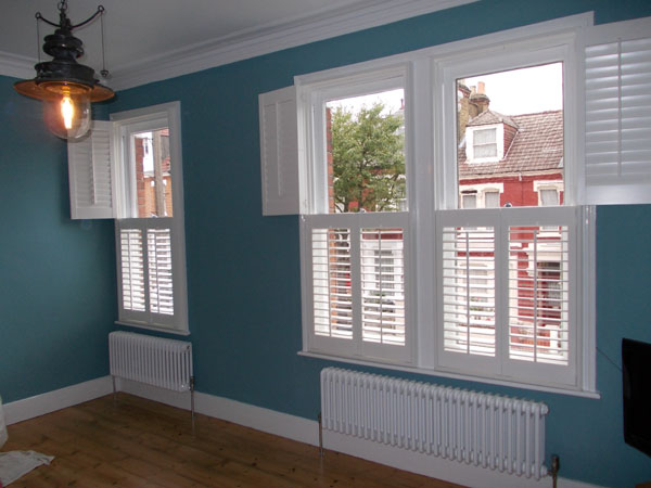 Tier on Tier white wood Plantation Shutters with 63mm louvres East London
