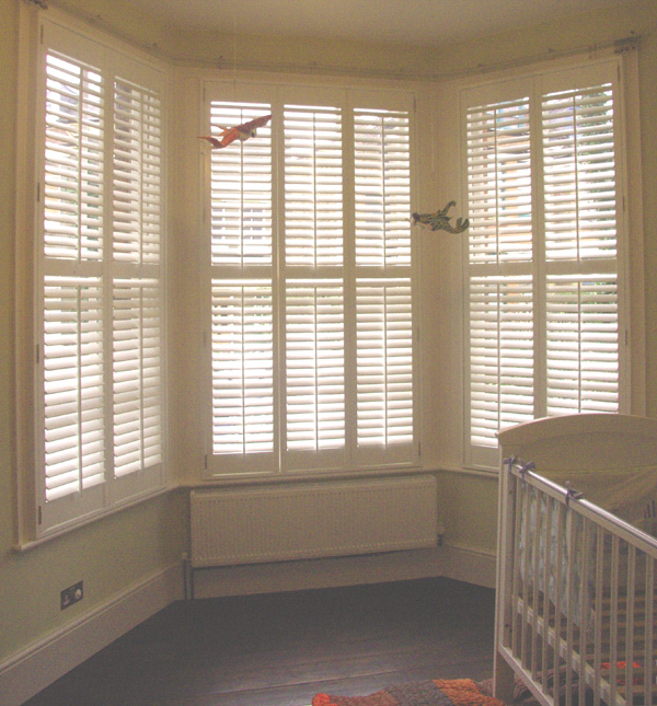 Painted wood plantation shutters in silk white with 63mm louvres - internal and external views