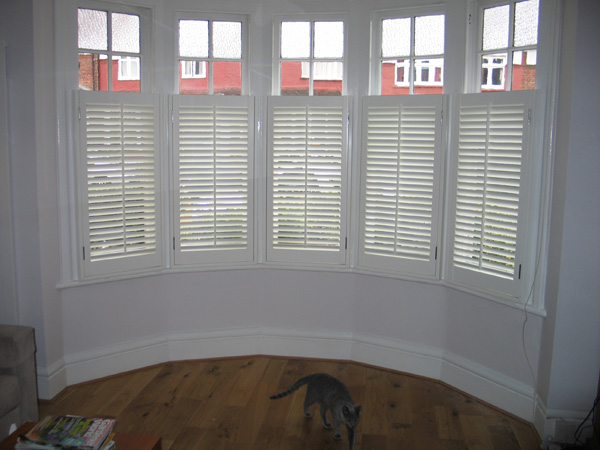 Silk white plantation shutters in wood with 47mm louvres