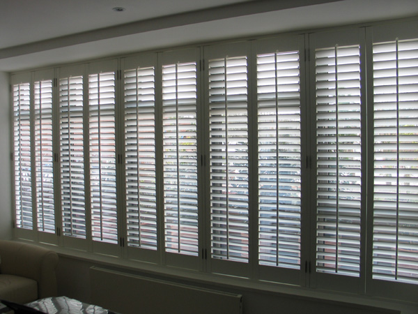 Silk white wooden plantation shutters with 63mm louvres