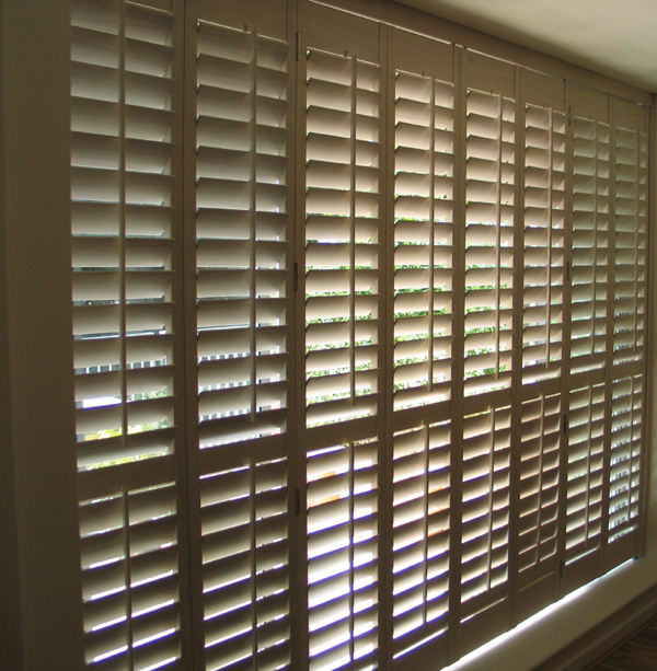 Full height Patio door shutters on a tracking system 63mm louvres, limed white stained wood