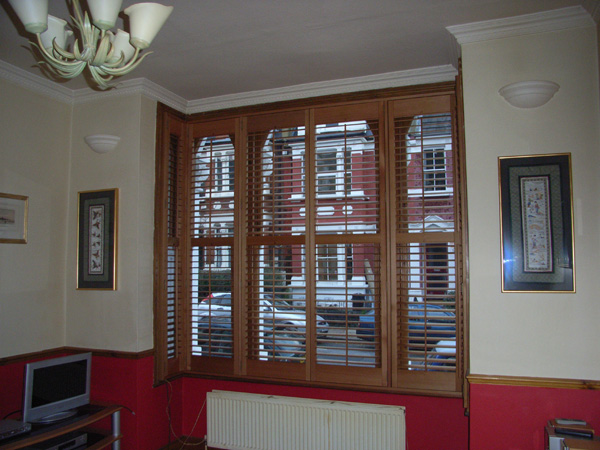 Plantation shutters in oiled cedar with 63mm louvres