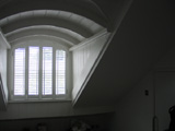 Plantation shutters installed in Holloway arched shape