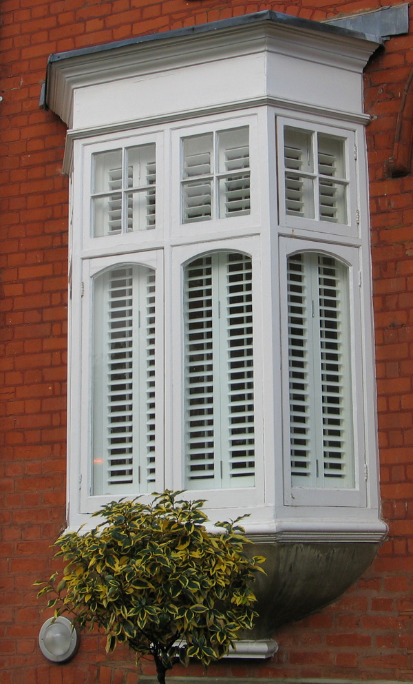 Silk white plantation shutters in wood with 63mm louvres internal and external shots