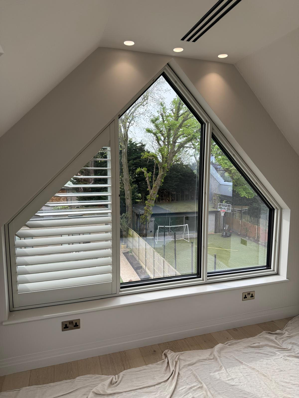 Triangular window shutters in East London detailing the shutter frame