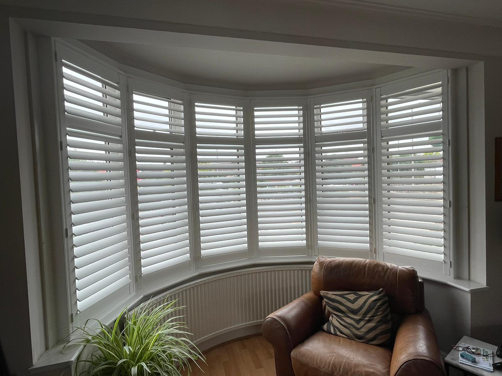 bay window after white wooden shutters are fitted in North London