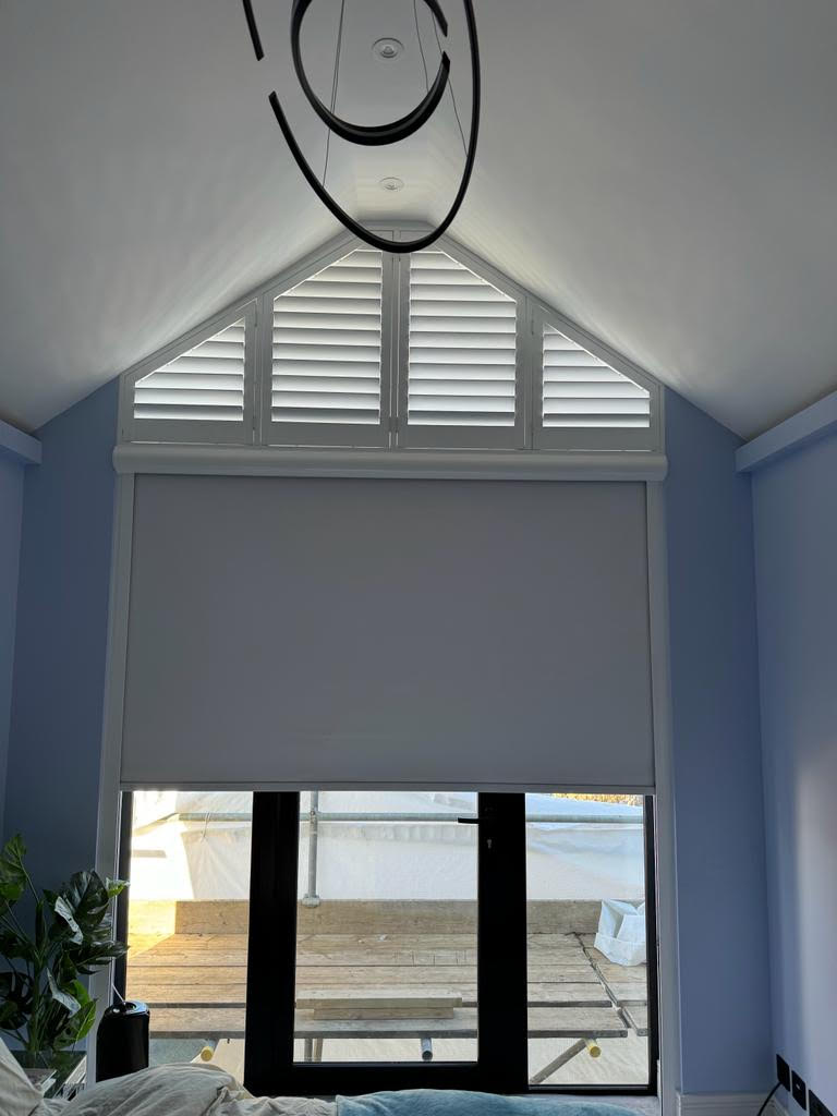 triangular wooden shutters above a cassetted blackout roller blind in Central London